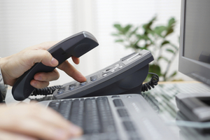 businessman is dialing a phone number in office